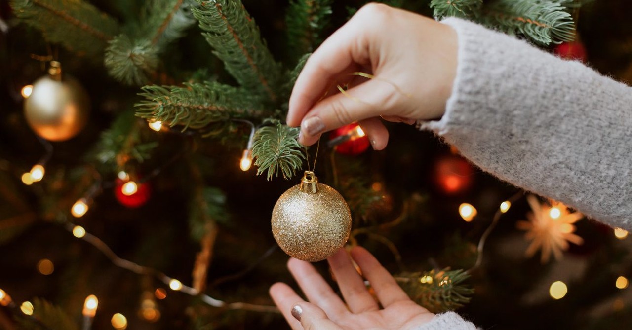 Woman decorating her Christmas tree