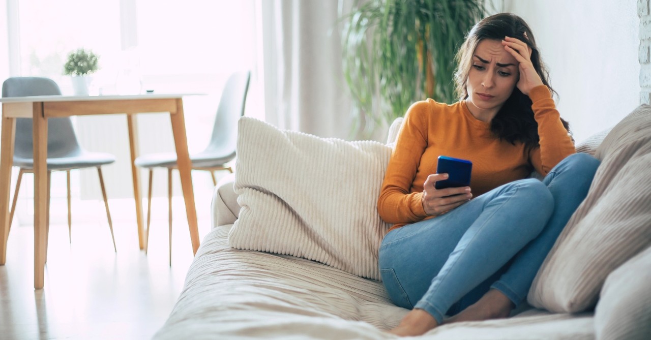 Woman looking scared while on her phone