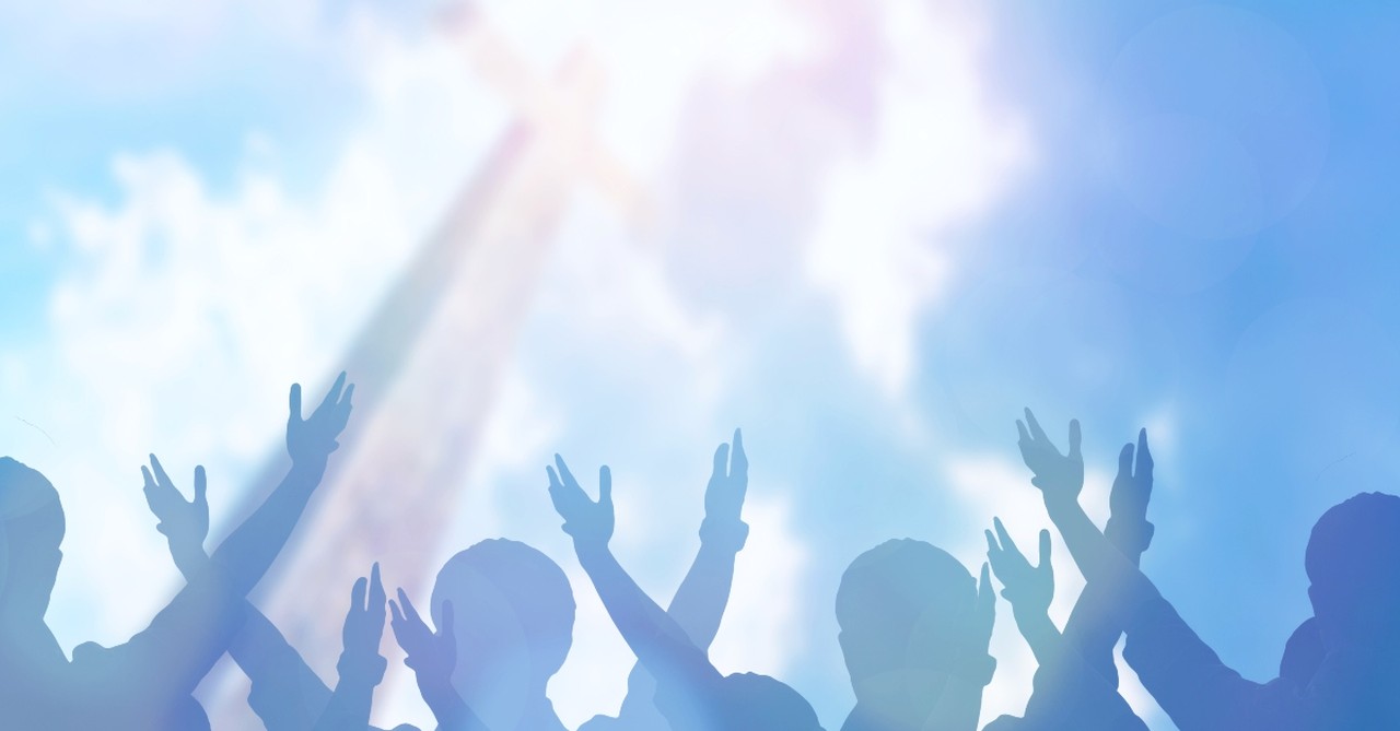 Blue sky believers praising the cross