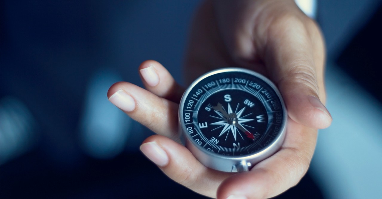 person holding a compass, most Americans believe the US moral compass is pointed in the wrong direction