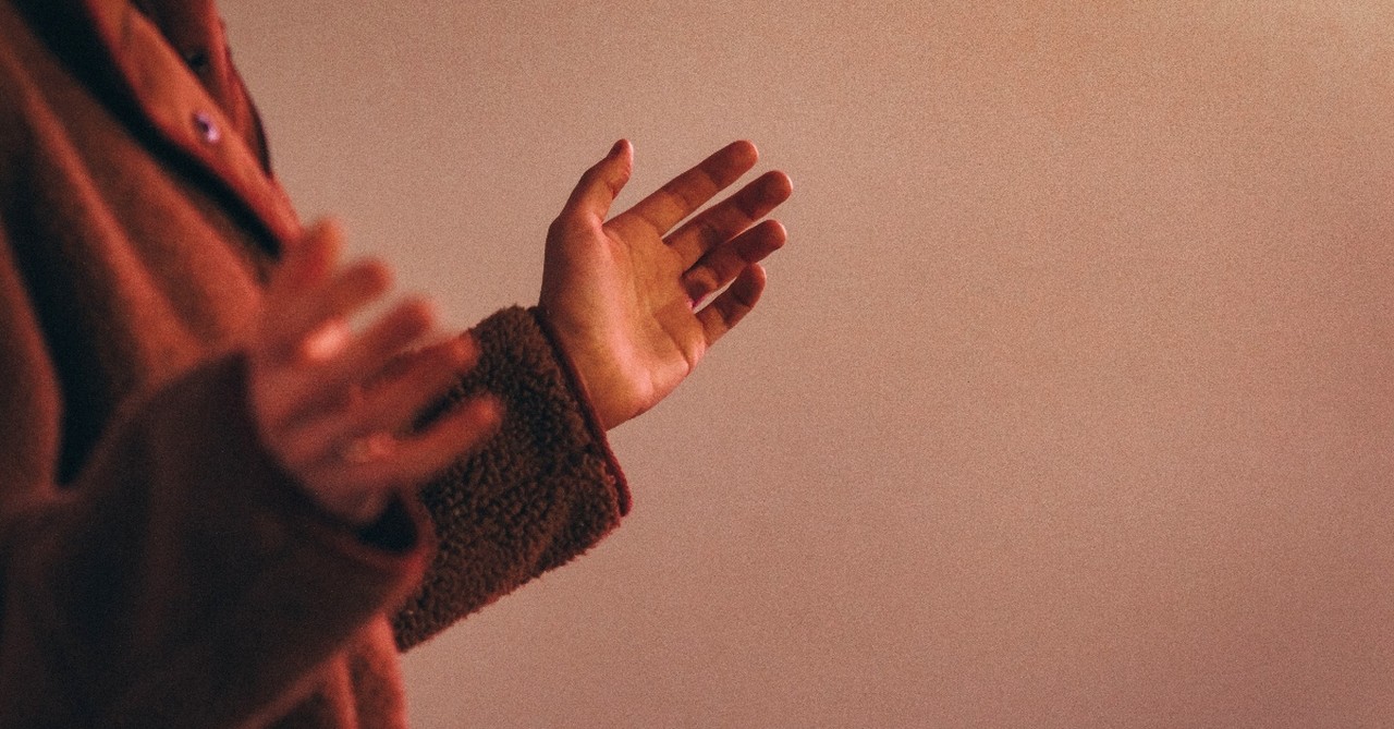 Woman holding her hands in praise