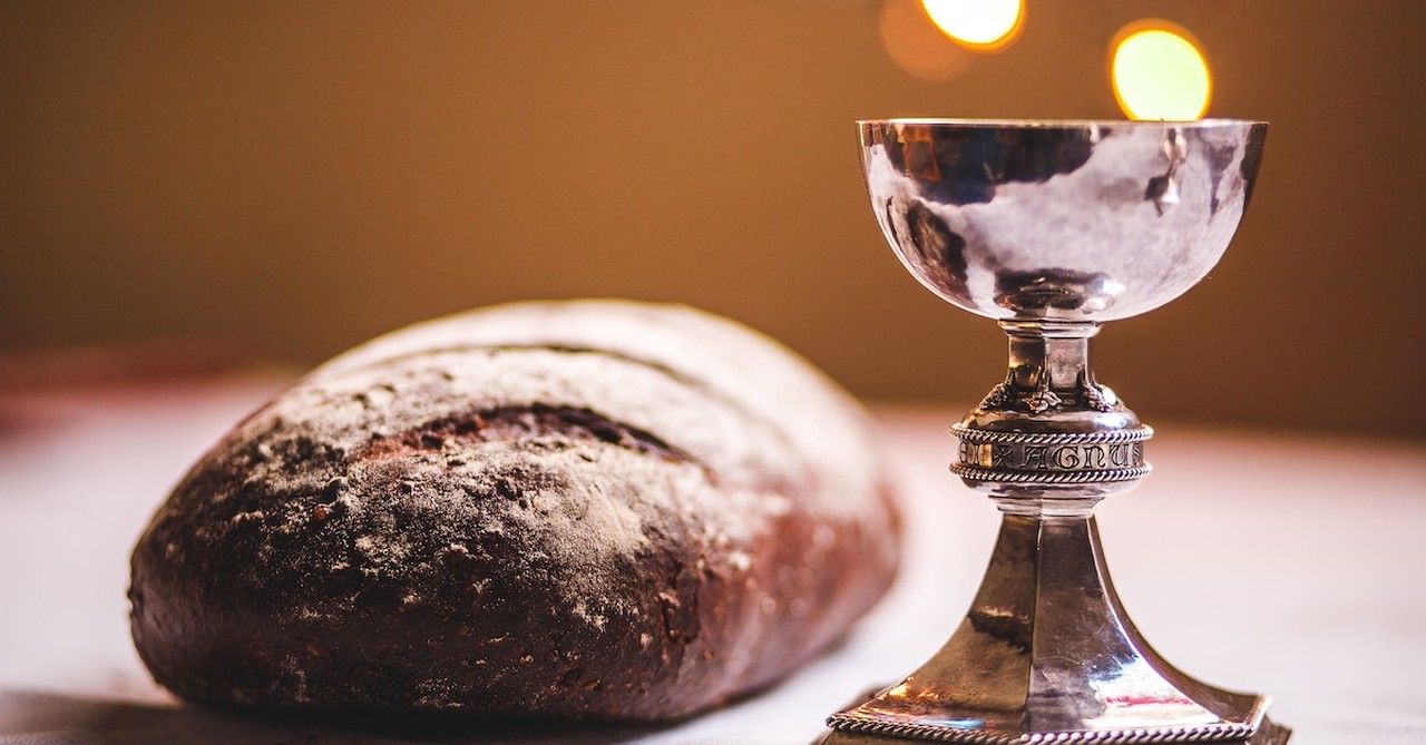 communion or eucharist set on table with loaf of bread and silver chalice, thankfulness challene