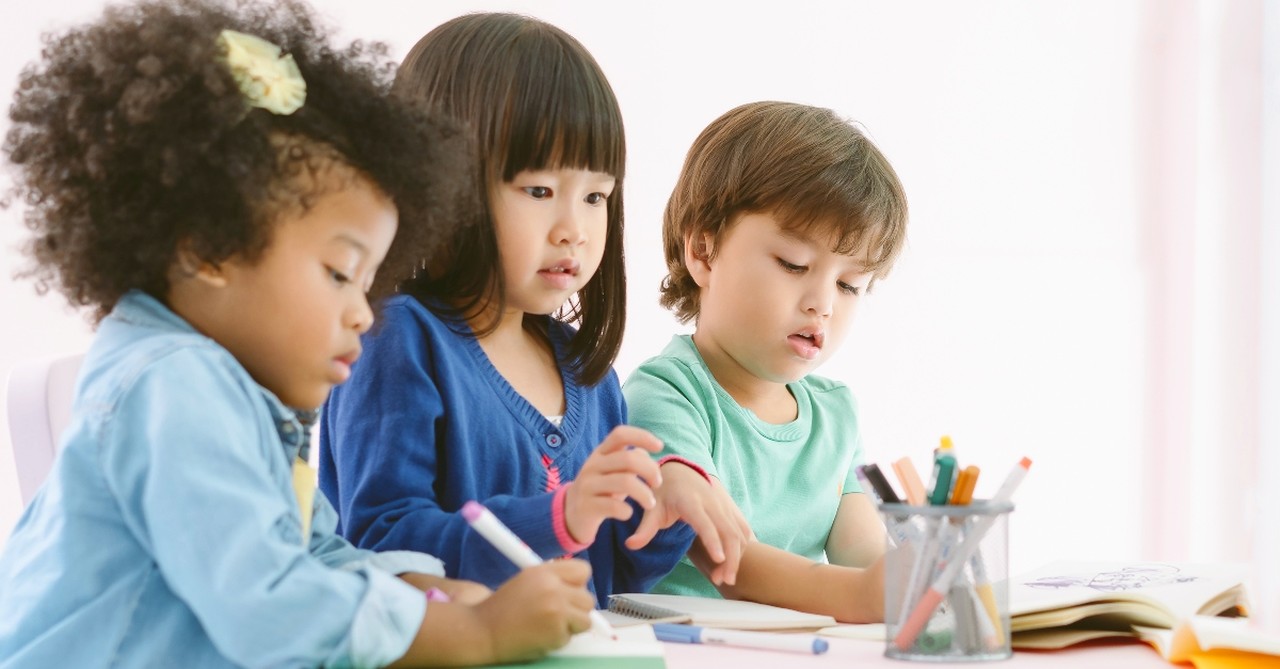 Three children coloring