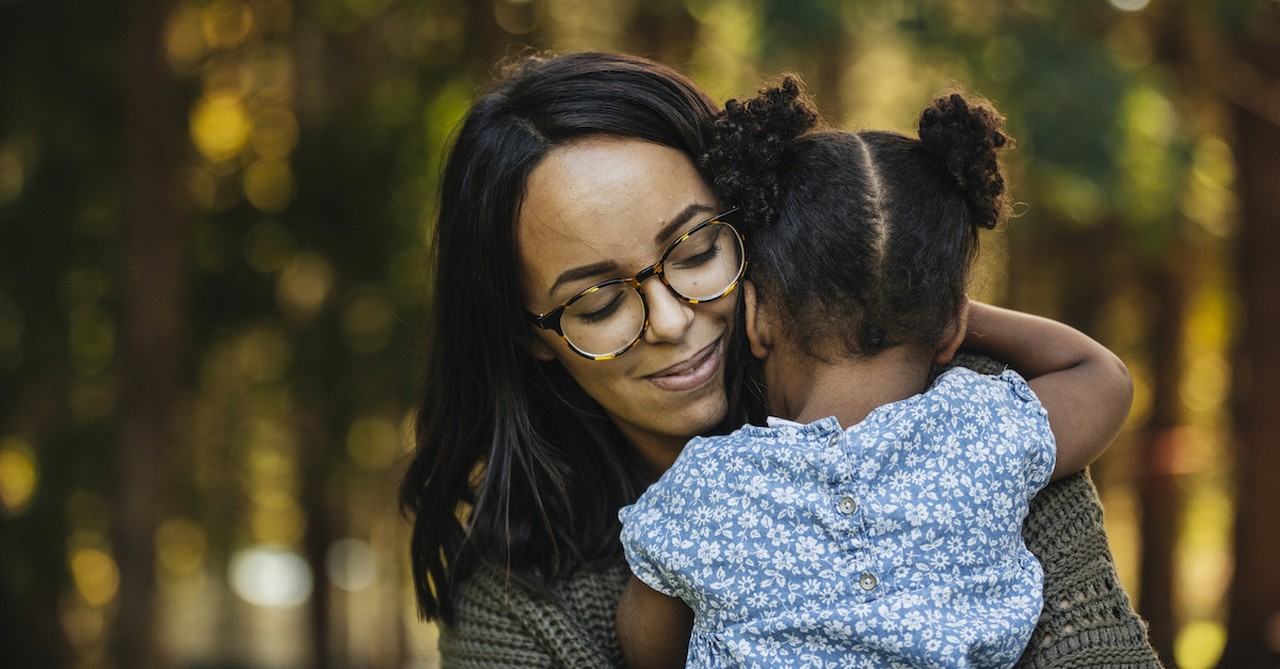 mother hugging young daughter