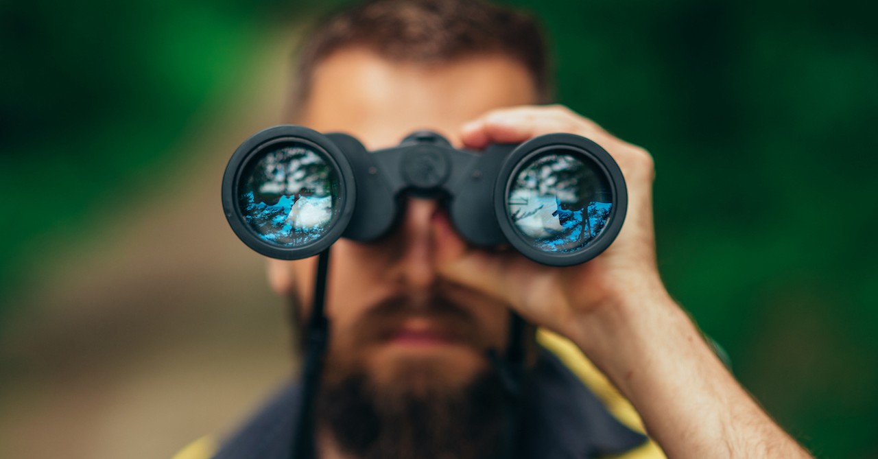 Man searching binoculars