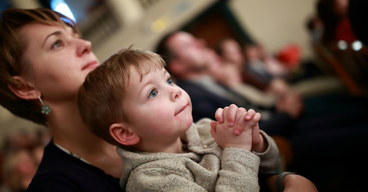 mother and son praying at church