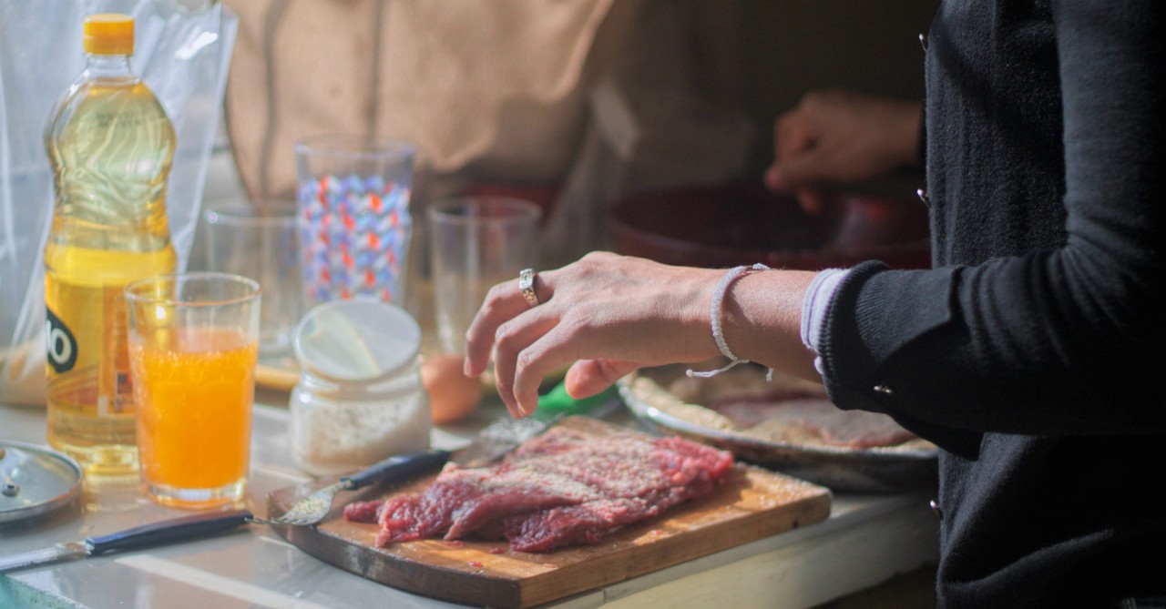 woman cooking steak dinner