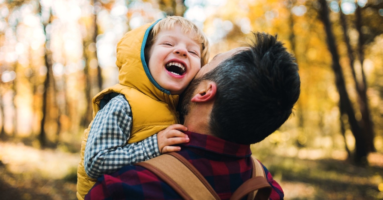 Father holding his laughing son
