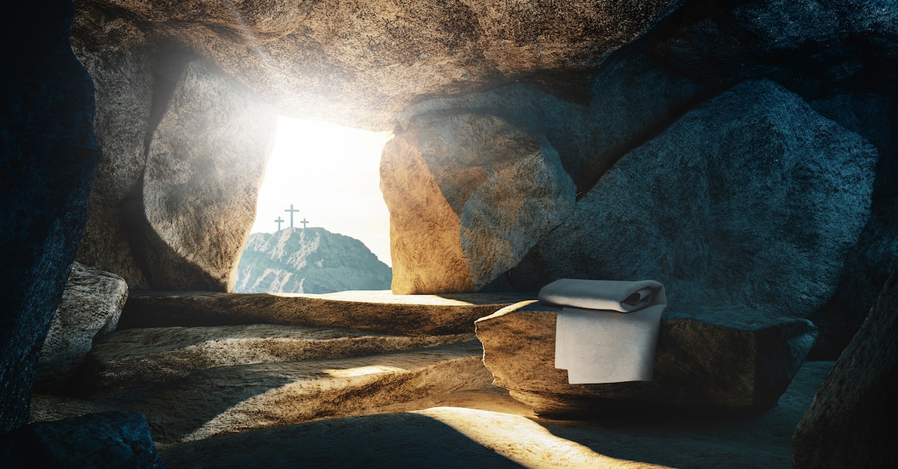 Jesus' empty tomb with crosses in the distance