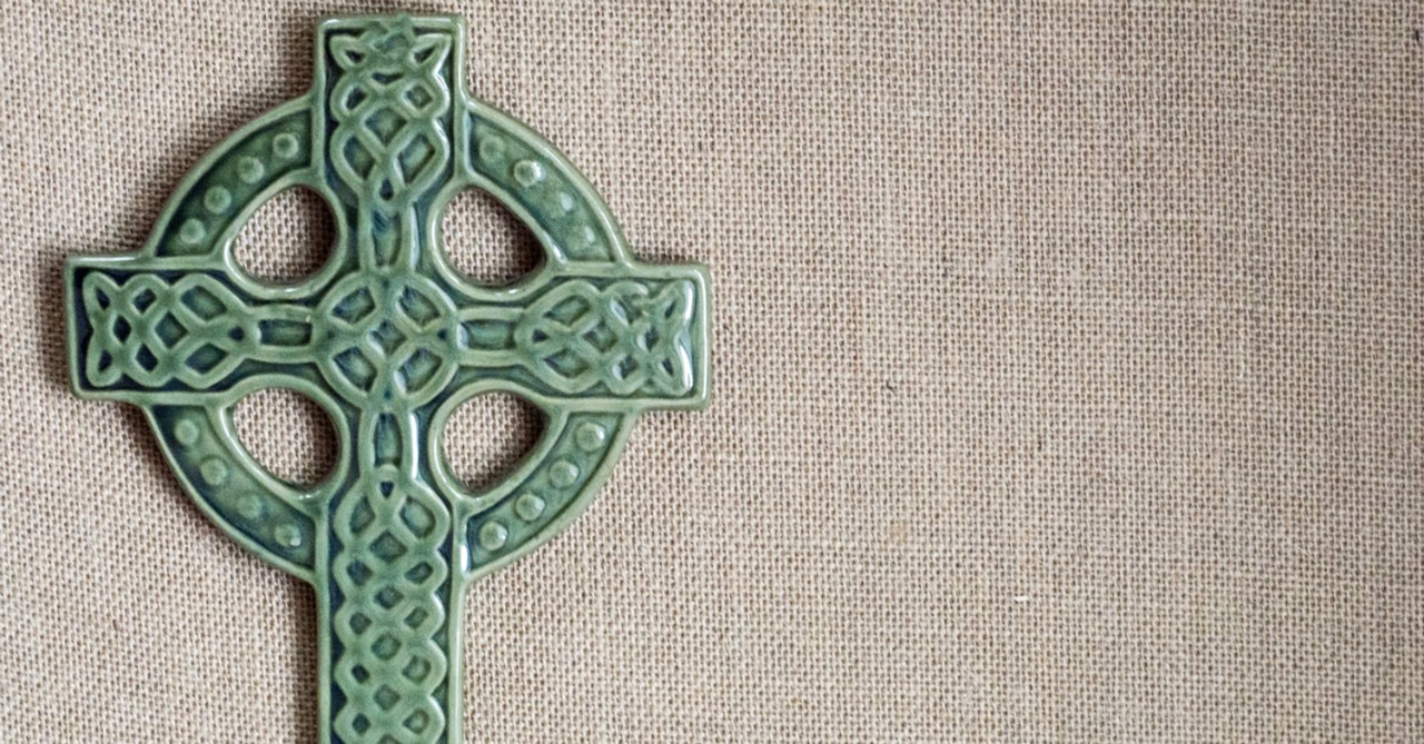 green celtic cross on beige background, st. patrick's day quotes and blessings