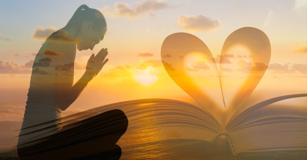 woman praying at sunset head bowing down