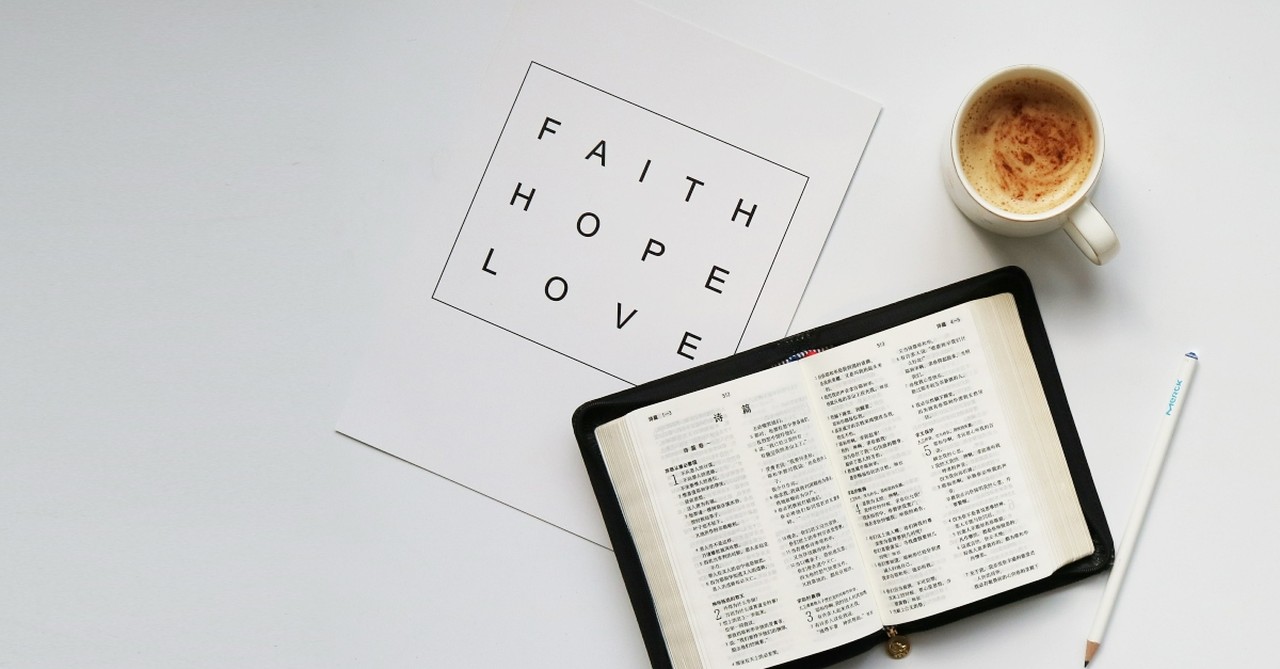 Faith hope and love on a paper near a Bible