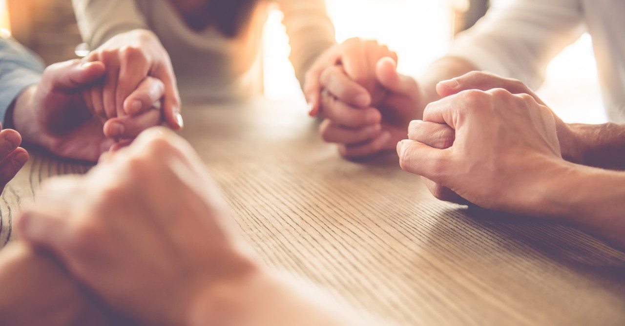 group holding hands praying together, nothing to worry about