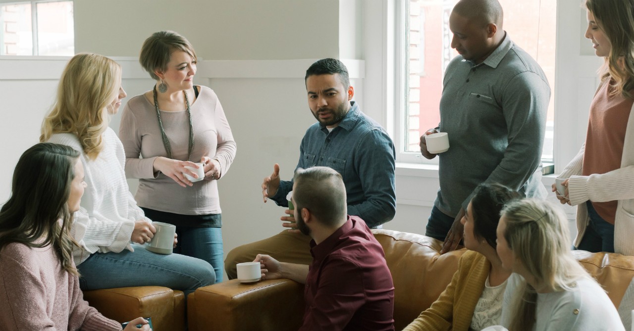 Young pastor talking to a group of people