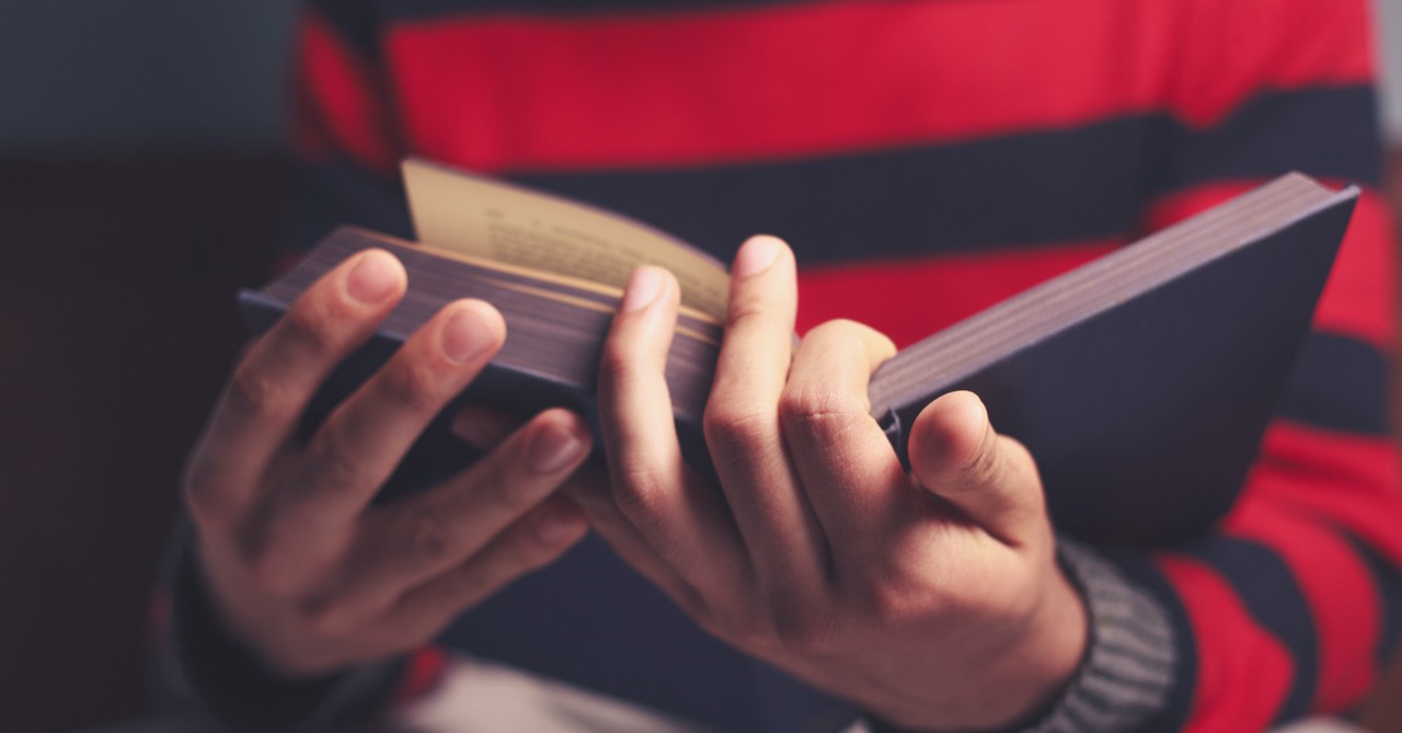 Close up of hands holding a Bible