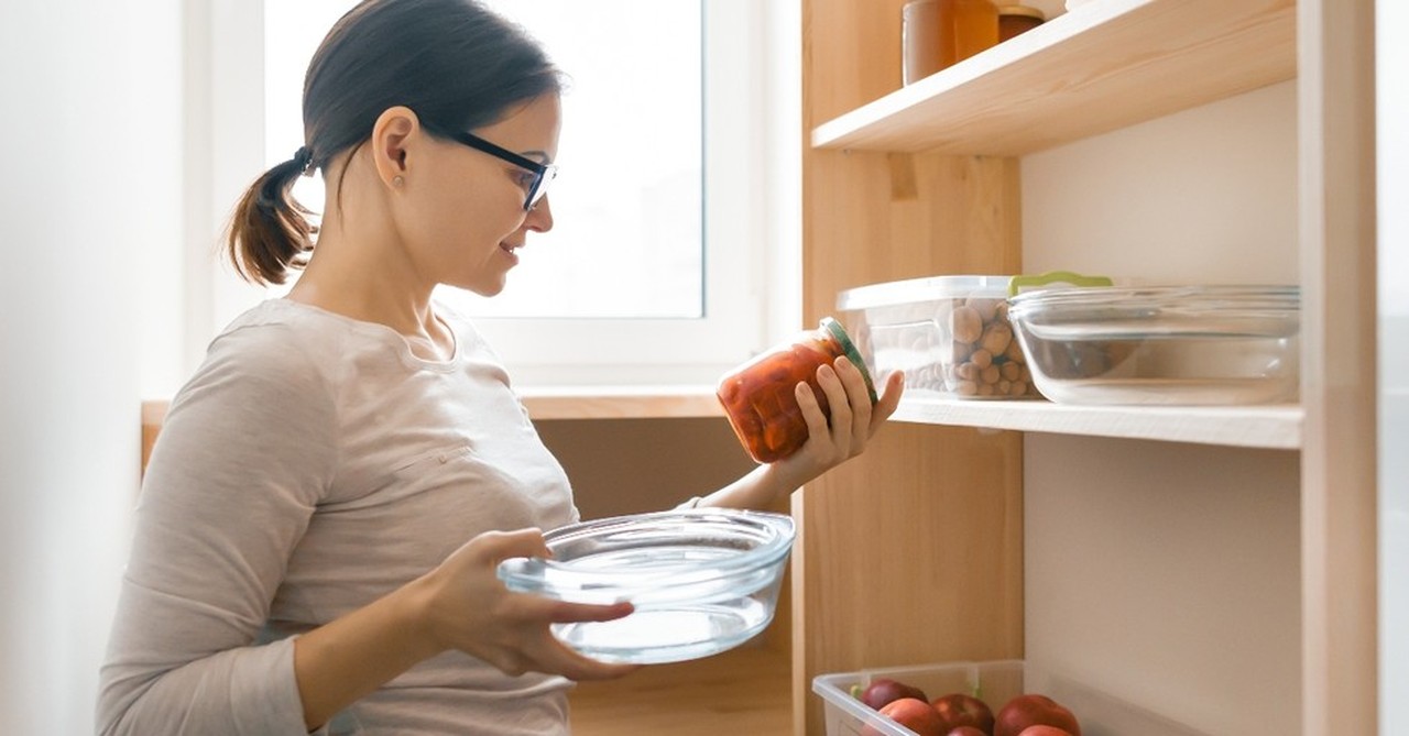 woman looking at food from pantry