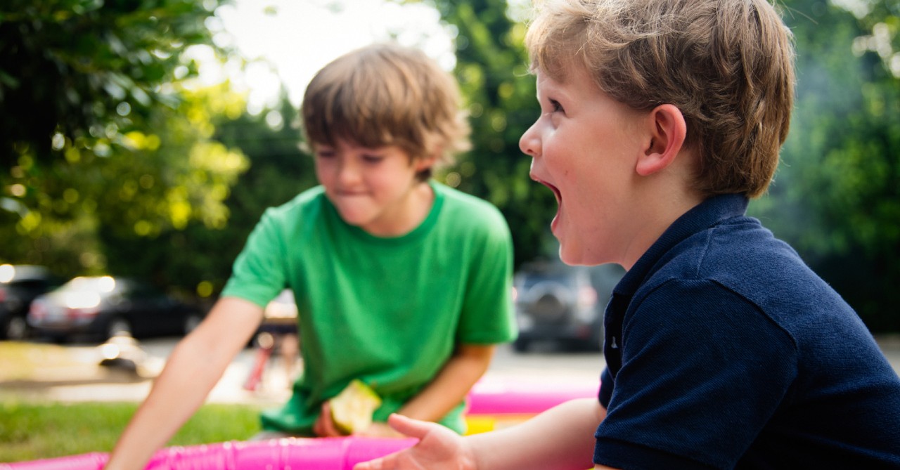 two boys playing outside, happy