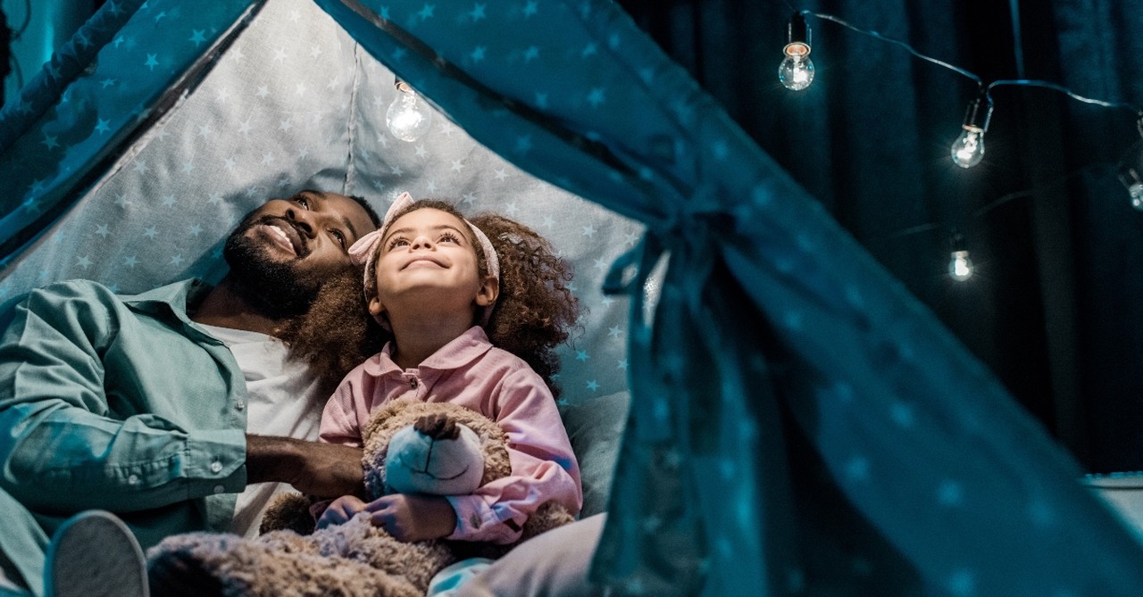 father and daughter in tent