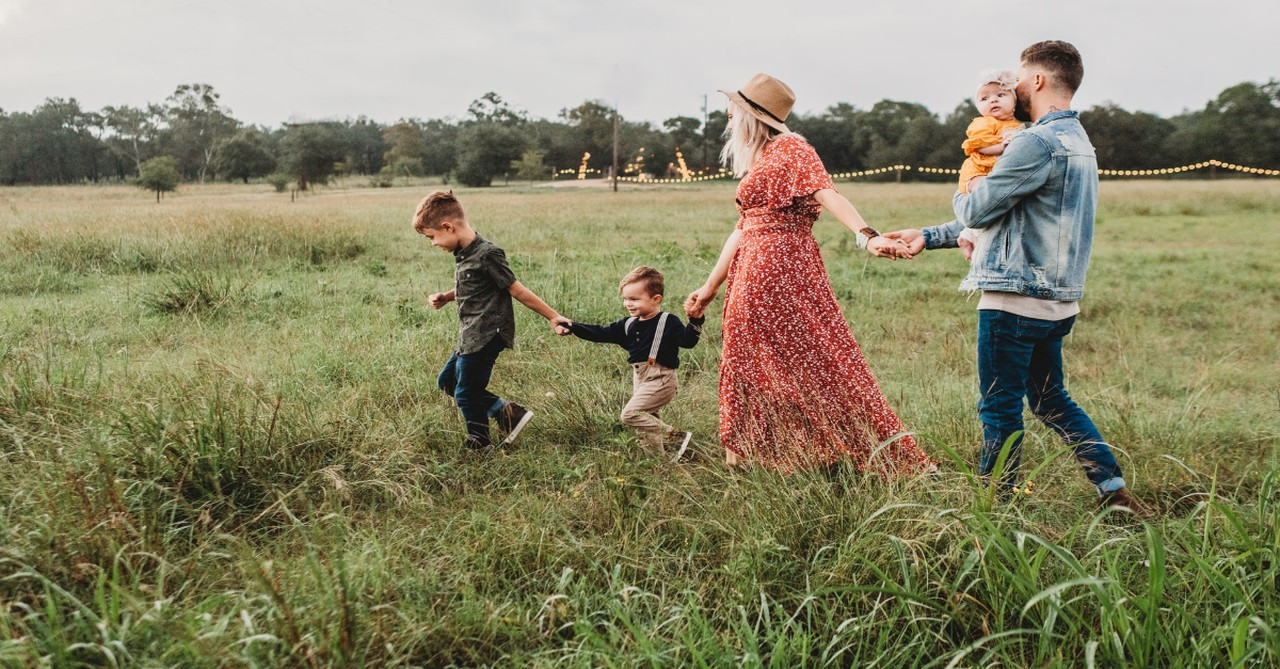 family holding hands walking through a field, weekend prayers