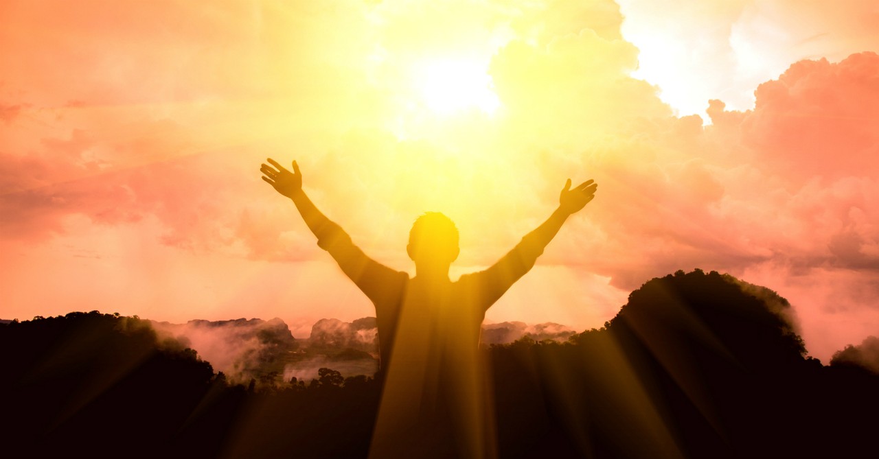 man with arms raised in joy, hymns to silence enemy's lies