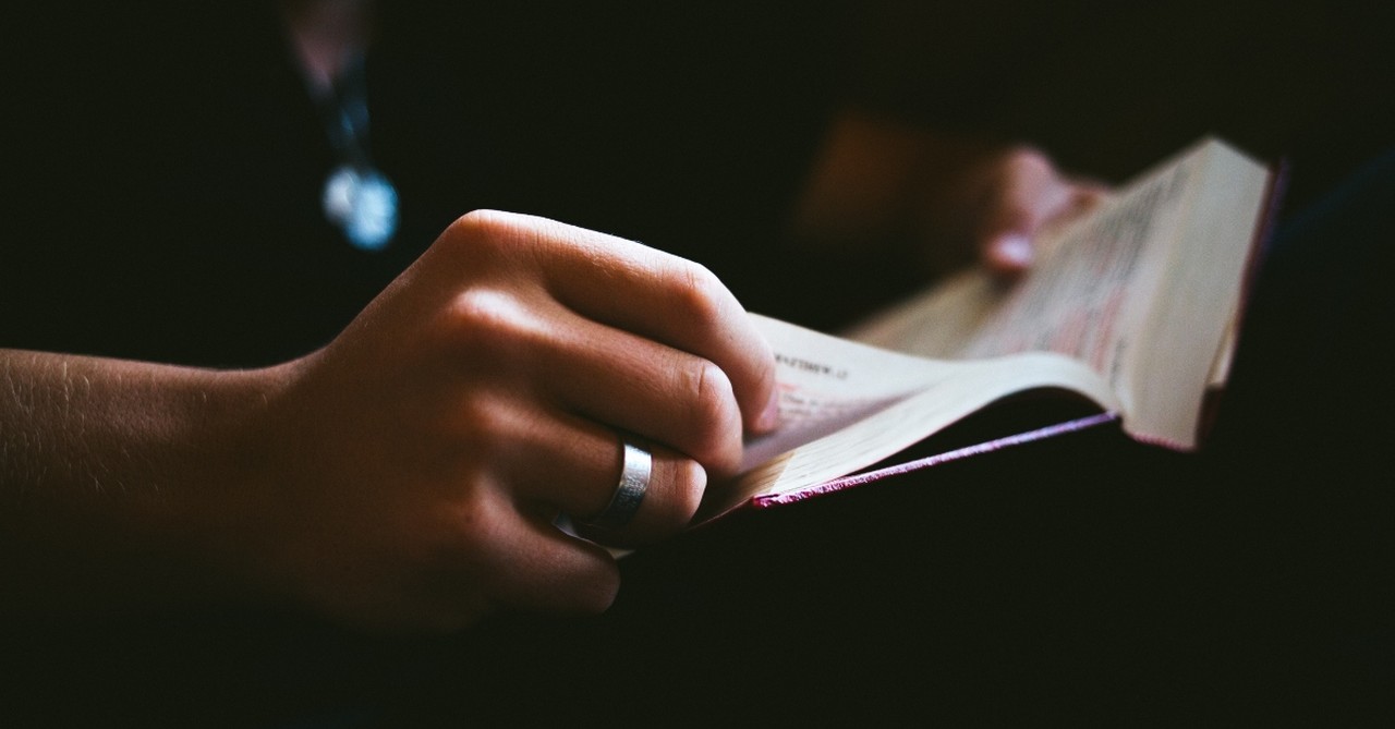 Person holding and reading a Bible