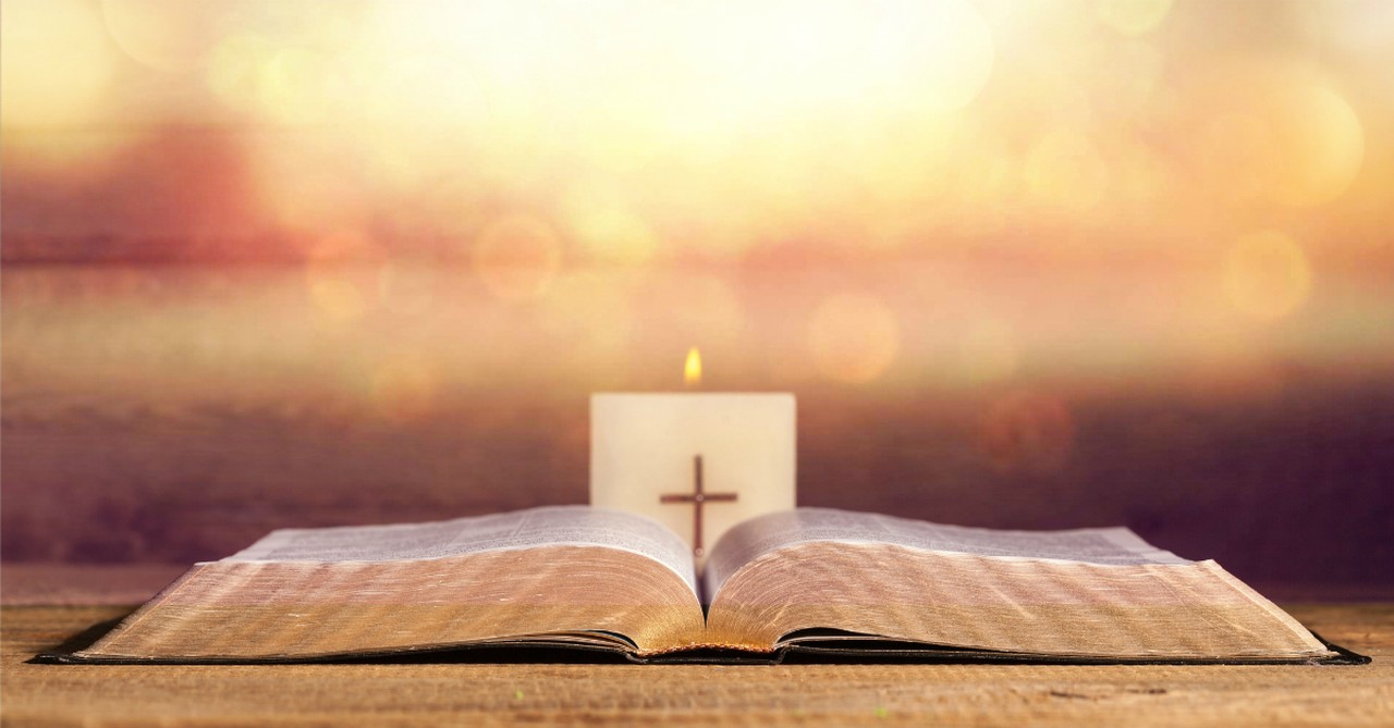 cross card on top of bible, holy week reading plan