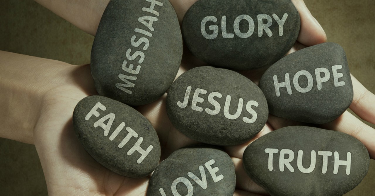 stones printed with words glory messiah faith love jesus