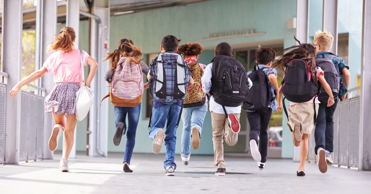 Kids running into a school, three boys are under investigation for using the 'wrong' pronouns