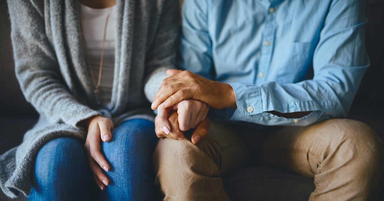 Husband holding wife's hand