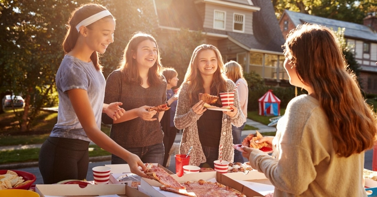 girls eating pizza neighborhood block party