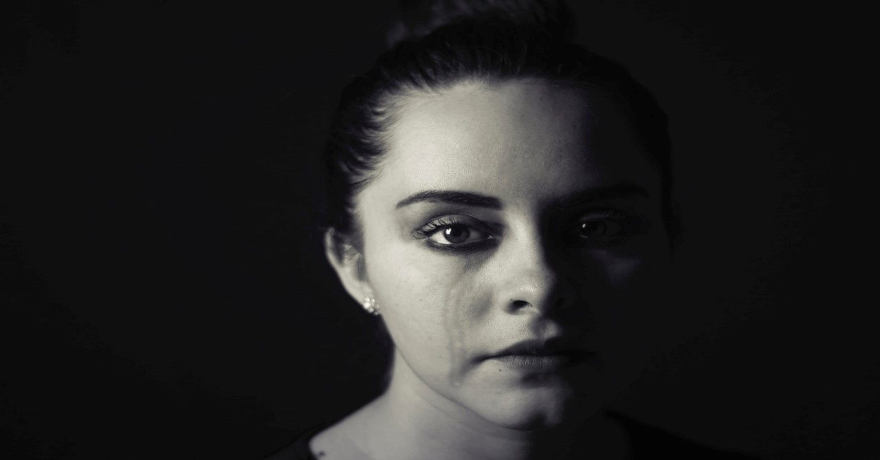Mourning woman with single tear