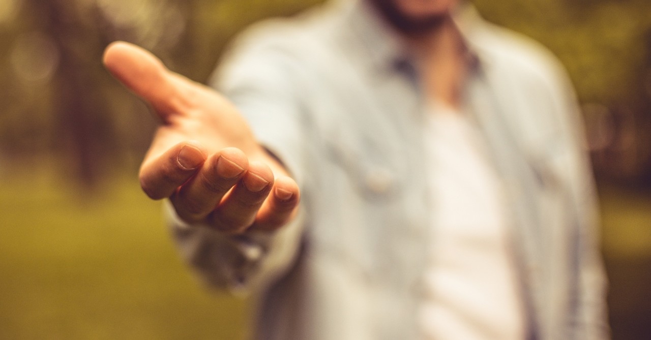 Close-up of a man offering a helping hand