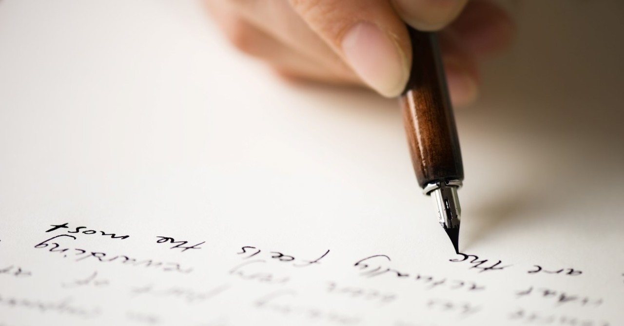 hand writing a letter