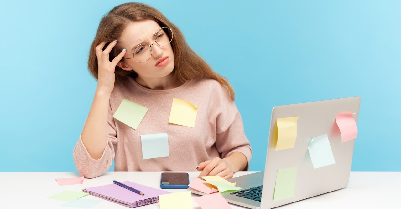 Woman with post-it notes and laptop