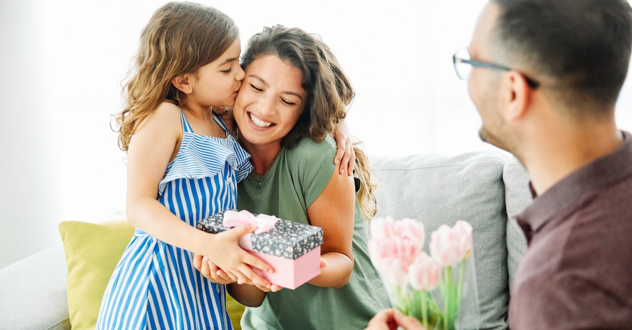 Husband and child giving mom gift