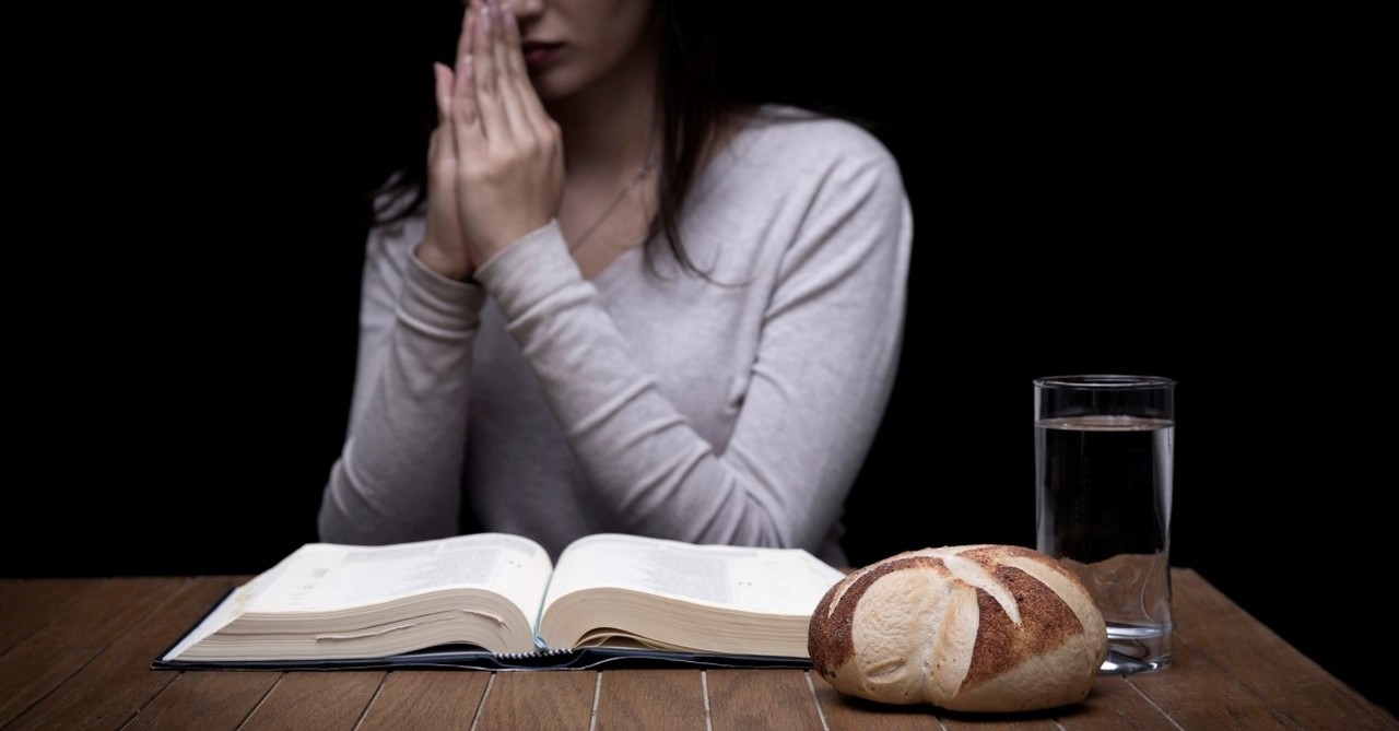 Young woman doing fasting and prayer in an interior