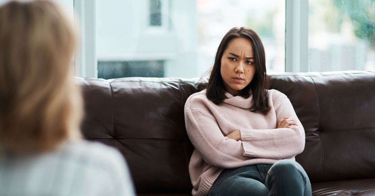 Upset woman listening to therapist