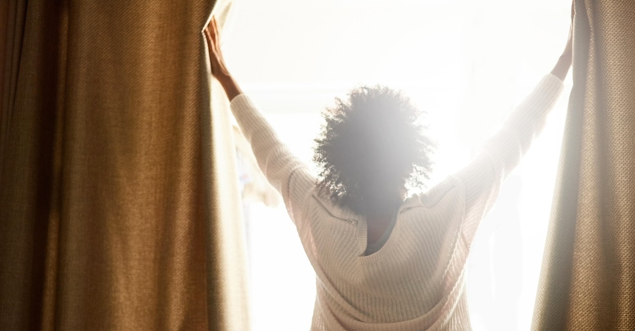 Woman waking to the morning sun