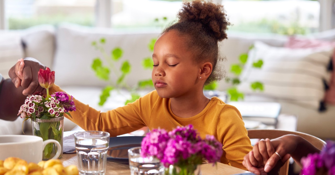 little girl praying before meal