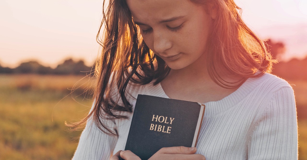 Girl holding a Bible, tuesday morning blessings