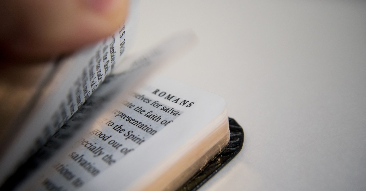 Book of Romans flipped open
