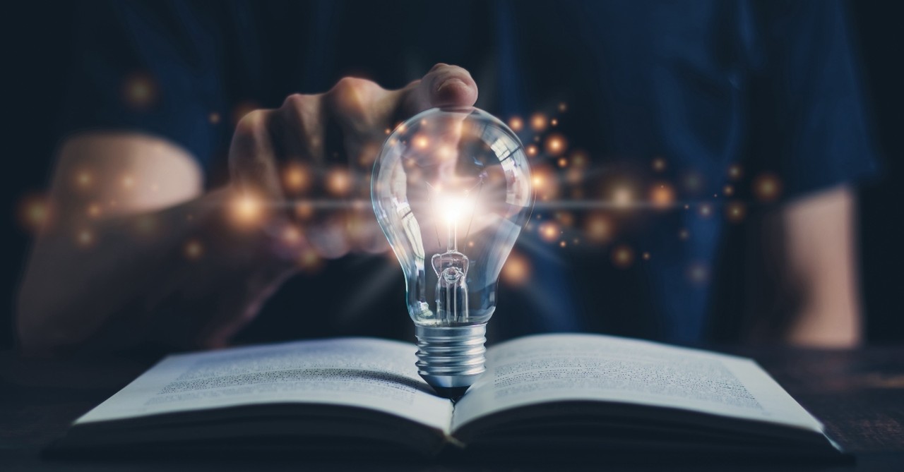 Lightbulb coming out of a book