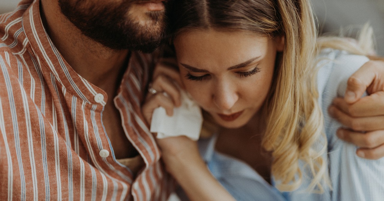 Sad couple parents crying grief and worry