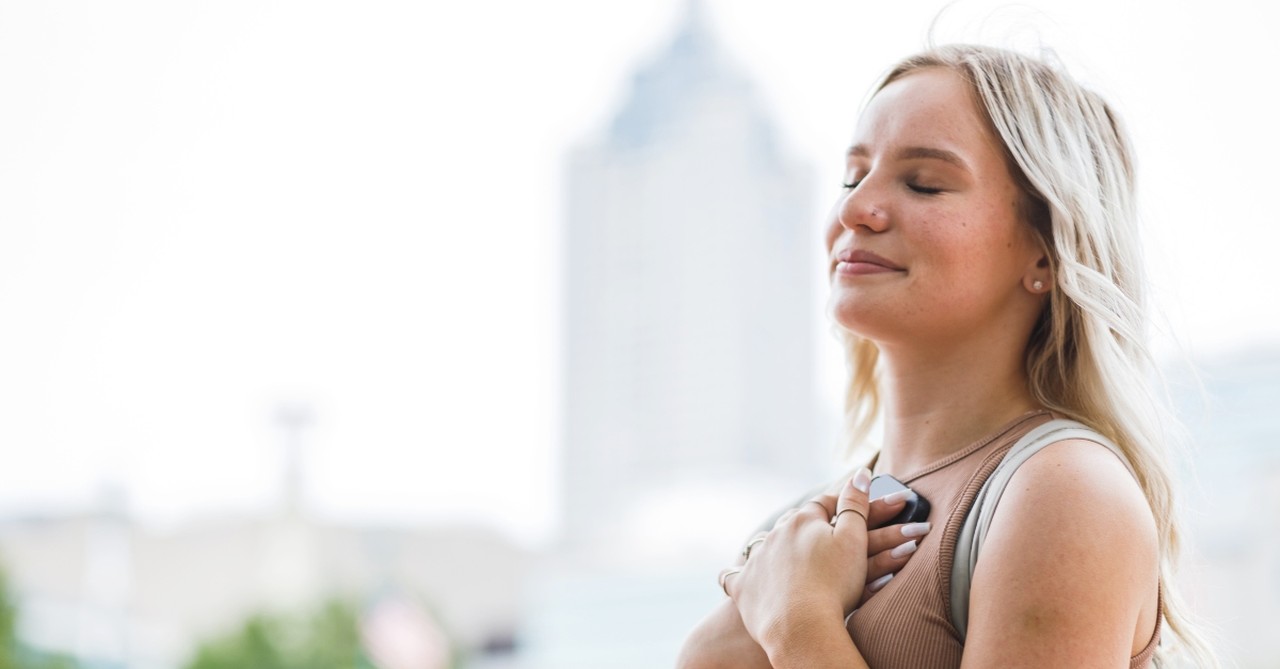 Woman with hand on heart to illustrate seek the kingdom of god