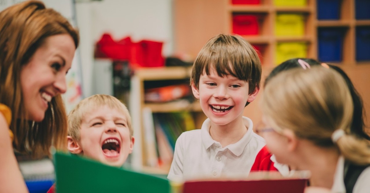 mother reading funny book to children, christian jokes