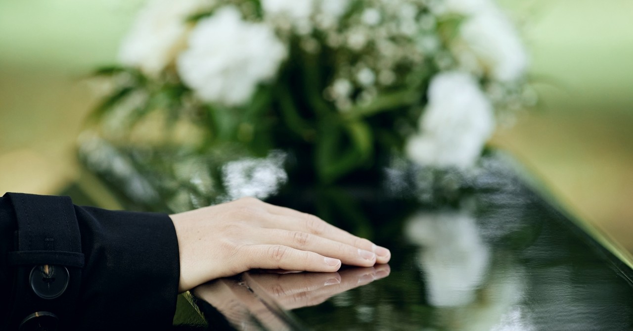 A hand on a casket