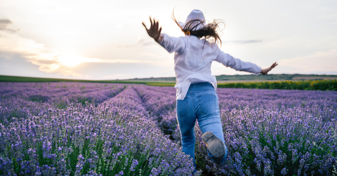 Woman running through a lavender field.