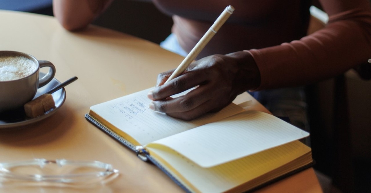 african-american woman writing at kitchen table, jackie hill perry