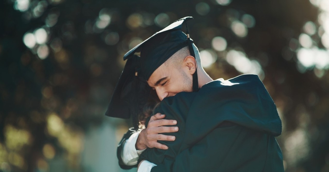 college graduates hugging