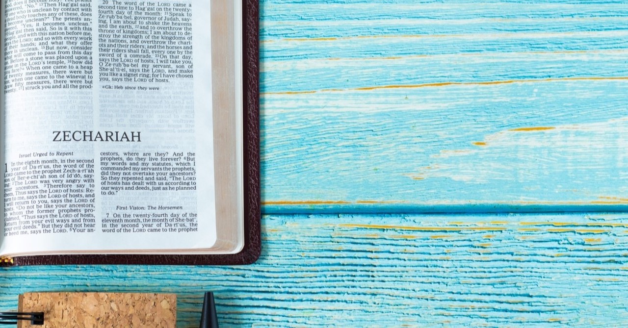 book of zechariah on blue table with notebook and pen, zechariah in the bible